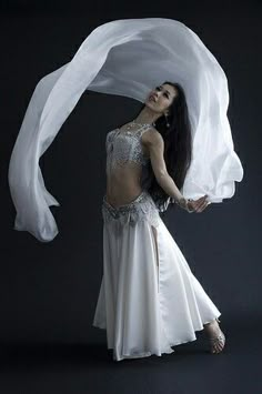 a woman in a white belly dance outfit