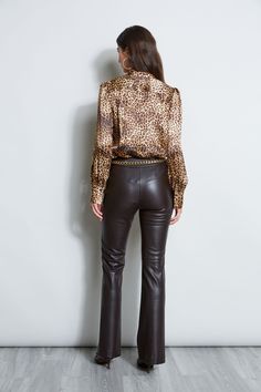 Our Ocelot inspired print takes a modern turn in Silk Satin. A band collar, soft sleeves & hidden placket lend an easy chic attitude. Wear it with jeans or our fluid crepe pants or vegan leather for a polished look. Elie Tahari Exclusive Silk Satin Ocelot Animal Print Button Down Shirt with Mandarin Collar 100% Silk Runs true to Size Model is 5'9" and wearing size S Length From Shoulder to Hem: Back 25.25"L , Sleeve: 32.5'L (approx. length for size S) Dry Clean Only Imported Style #: E904G503 Chic Attitude, Crepe Pants, Leather Pants Outfit, House Fashion, Easy Chic, Tahari Dress, Leather Jacket Outfits, Pants Outfits, Fashion Aesthetics