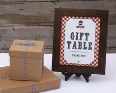 a gift table with two boxes and a sign