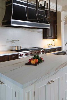 a kitchen with an island and stove top oven