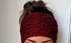 a woman wearing a red knitted headband