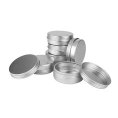 several metal tins stacked on top of each other with one empty container in the middle