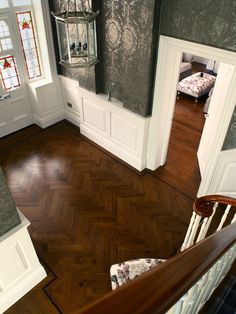 an aerial view of a house with wood floors and white trim on the door, windows, and stairs