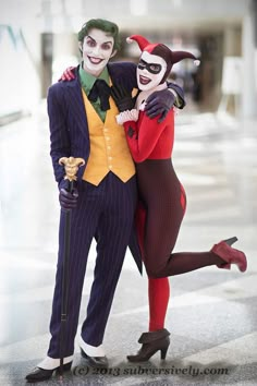 two people dressed up as the joker and catwoman pose for a photo together in front of a building