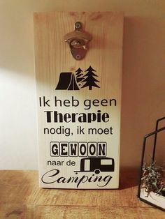 a wooden sign that says it's the best time to go camping on a table