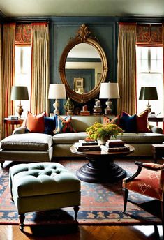 a living room filled with lots of furniture next to a window covered in drapes