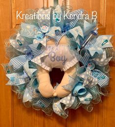 a blue and white baby wreath with a teddy bear