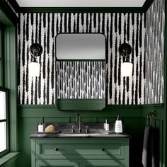 a bathroom with green painted walls and black and white wallpaper on the vanity area