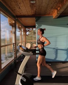 a woman is running on a treadmill