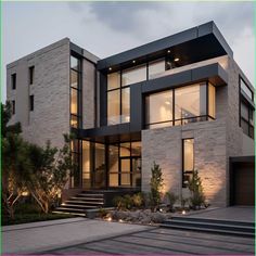 a modern house with lots of windows and steps leading up to the second story area