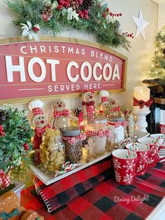 a christmas themed hot cocoa bar with red and white checkered tablecloth