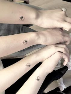 three girls with matching tattoos on their arms