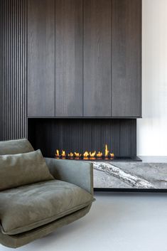 a living room with a couch and a fire place in the middle of the room