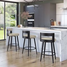 a kitchen with marble counter tops and bar stools