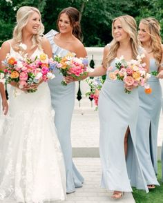 the bridesmaids are holding their bouquets and smiling at each other while they walk down the aisle