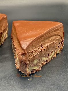 two pieces of chocolate cake sitting on top of a table