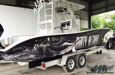 a black and white boat parked in a garage