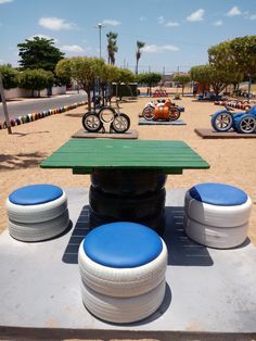 an outdoor play area with blue and white tires