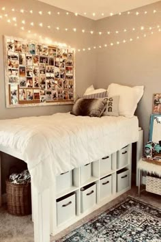 a white bed sitting under a light filled ceiling