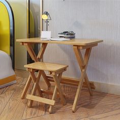 a small wooden table with two stools next to it