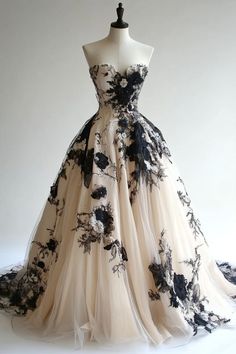 a dress on a mannequin with black and white flowers in the skirt,