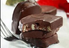 three pieces of chocolate on a plate with a fork