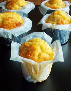 several muffins sitting in paper cups on a table