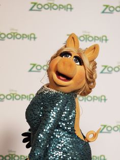 the miss piggy doll is wearing a sequin dress