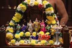 a shrine with flowers and figurines on it