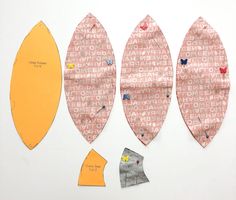 three pieces of paper cut out to look like surfboards with different shapes and sizes