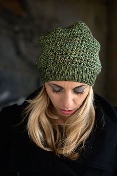 a woman wearing a green knitted hat