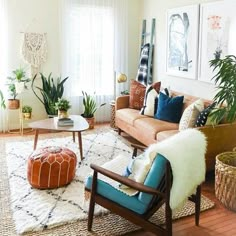 a living room filled with furniture and plants