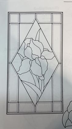 an image of a stained glass window with flowers in the center and leaves on it