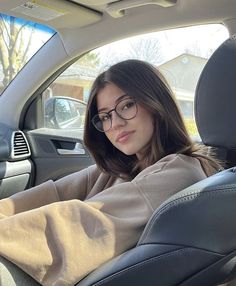 a woman sitting in the back seat of a car