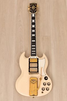 an electric guitar sitting on top of a wooden floor