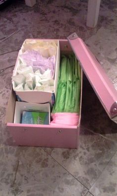 an open pink box filled with lots of different items