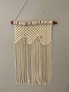 a macrame wall hanging on the wall