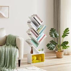 a stack of books sitting on top of a white book shelf in a living room