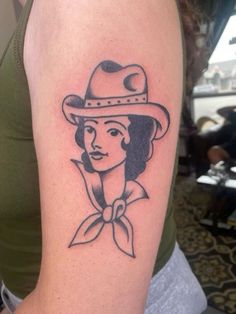 a woman with a hat on her arm