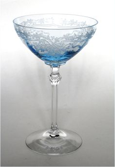 an empty blue glass sitting on top of a table