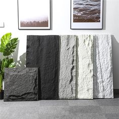 three different types of stone sitting next to each other in front of pictures on the wall