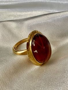 Beautiful KJL vintage ring featuring gold tone metal and beautiful large oval amber.  Ring size 6. Gold Ring With Large Oval Cabochon Stone, Gold Oval Ring With Large Stone, Formal Amber Oval Cabochon Rings, Elegant Amber Ring With Large Stone, Gold Oval Dome Ring With Cabochon, Gold Oval Dome Ring With Gemstone, Vintage Gold Dome Ring With Oval Cabochon, Oval Amber Cabochon Ring, Amber Oval Cabochon Rings