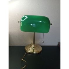 a green lamp sitting on top of a table