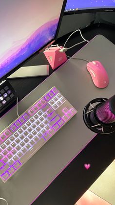 a desk with a keyboard, mouse and cell phone sitting on it next to a monitor