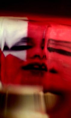 a blurry image of a woman's face in red and white