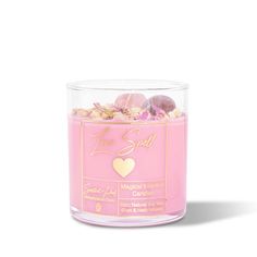 a pink candle that has some candy in it