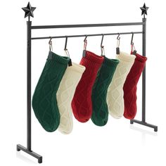 three christmas stockings hanging on a rack