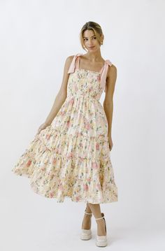 A realistic warm floral print midi dress. It shows a ruffled edge straight neckline, thick ribbon self-tie straps, and a smocked upper body. It also has a ruffled flowy midi bottom. 100% COTTON Pastel Floral Dress, Gown Sewing Pattern, Along For The Ride, Playsuit Dress, Church Dresses, Floral Print Midi Dress, Print Midi Dress, Straight Neckline, Dress Gift