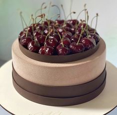 a cake with chocolate icing and cherries on top