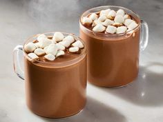 two mugs filled with hot chocolate and marshmallows